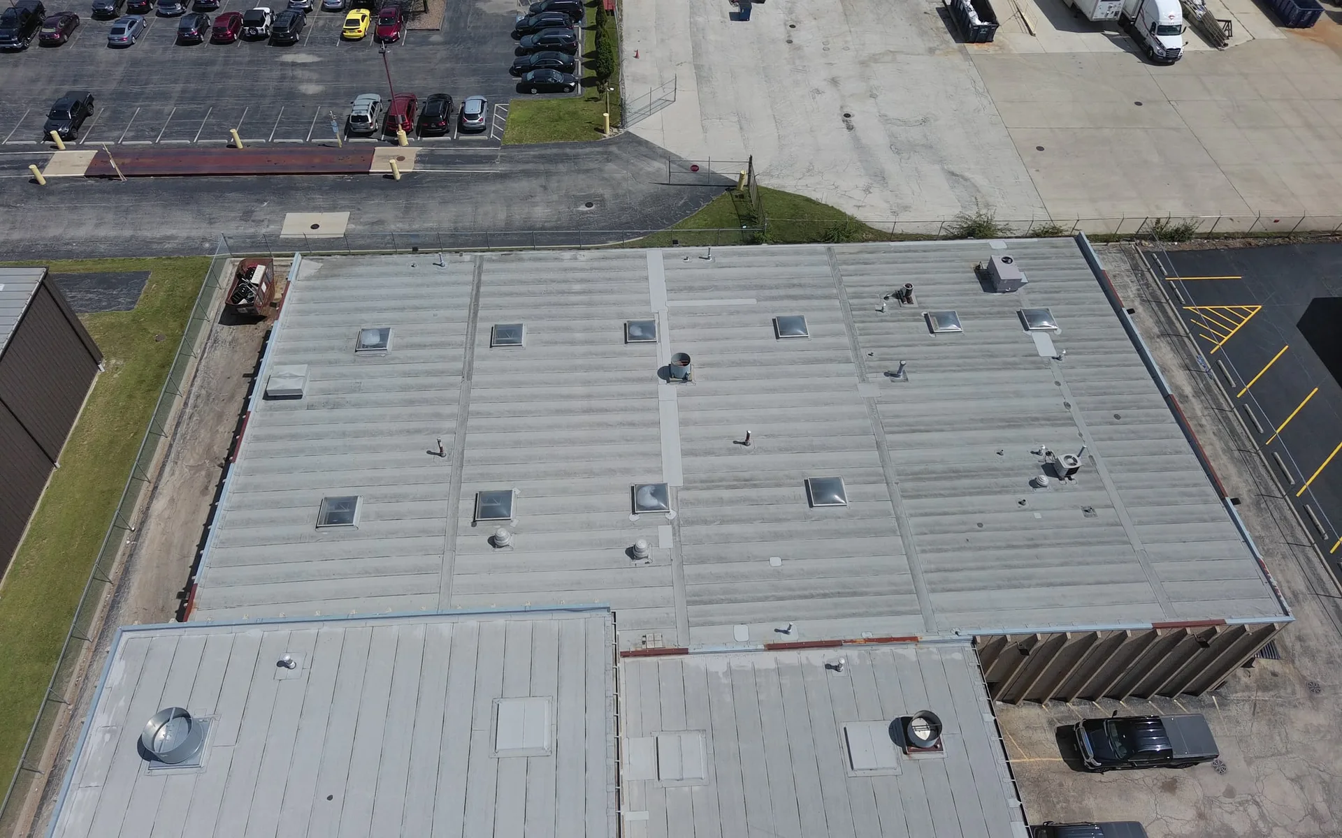 Aerial drone view of an Americanstruction crew on a large low-slope commercial roof