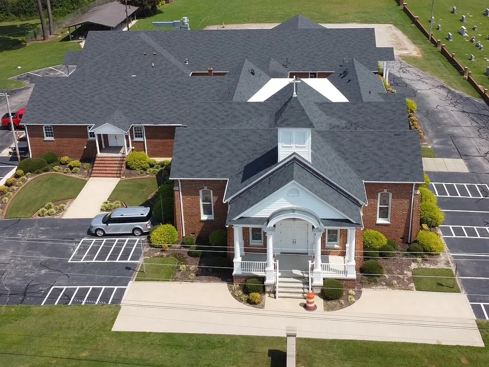Front view of church with shingle roof serviced by Americanstruction