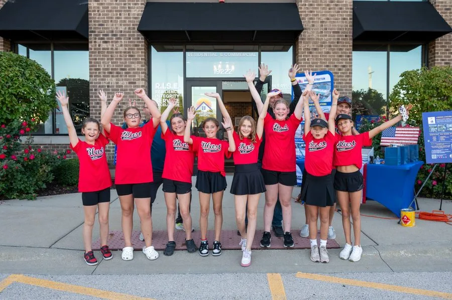 Americanstruction-sponsored Mokena Blast youth team outside the Mokena office