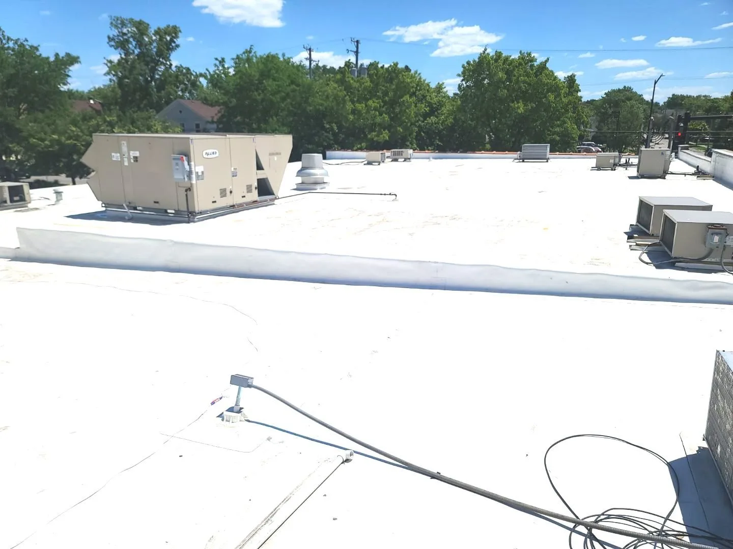 Completed white TPO roof on Aurora IL retail center after tear-off