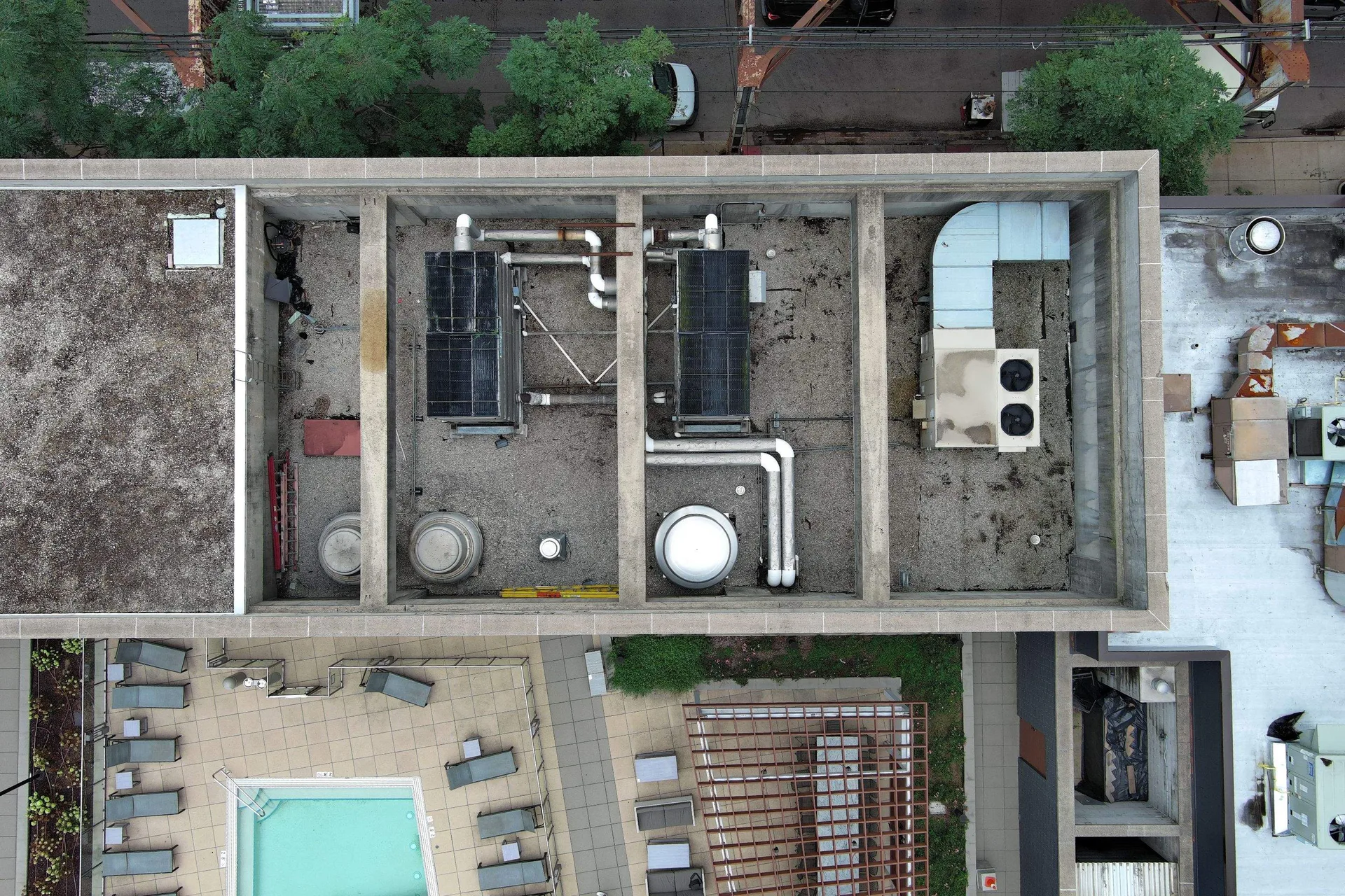 Aerial drone view of ballasted EPDM roof on Chicago multi-family apartment building after maintenance and vegetation removal
