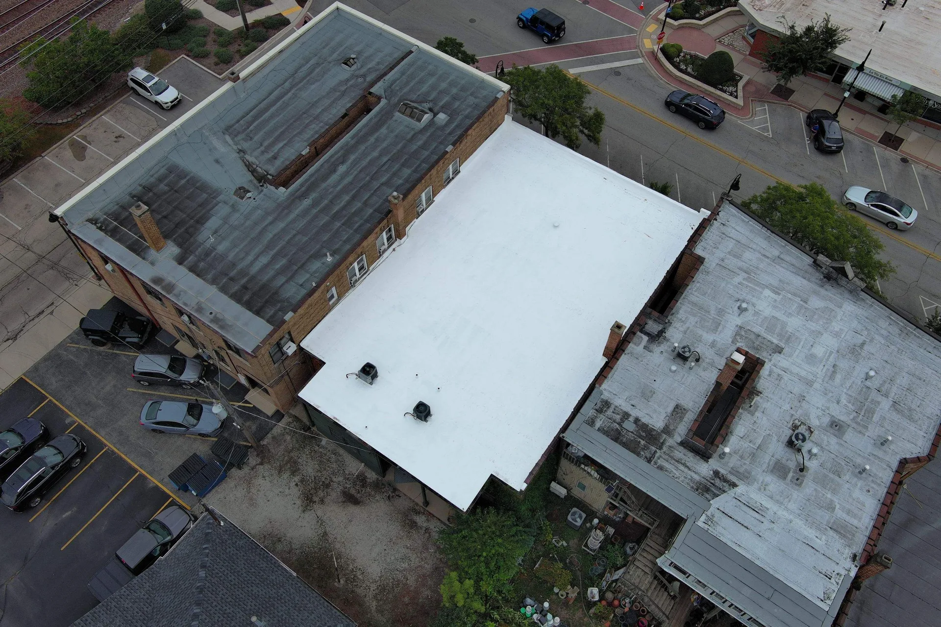 Aerial view of completed reflective roof coating on retail center in Clarendon Hills IL