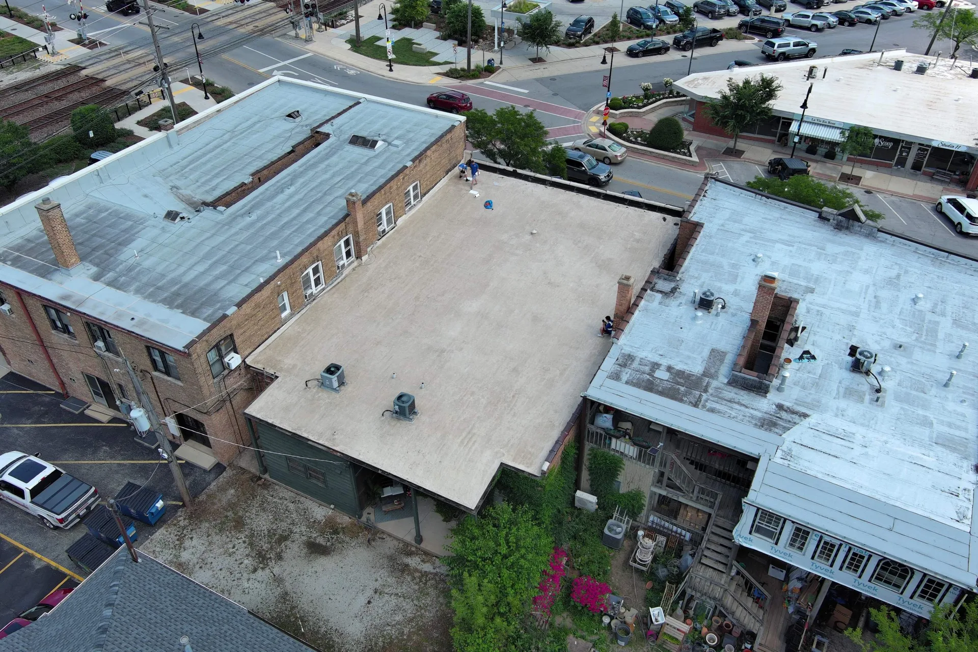 Aerial view of aging flat roof on retail center at 6 S Prospect in Clarendon Hills IL before coating