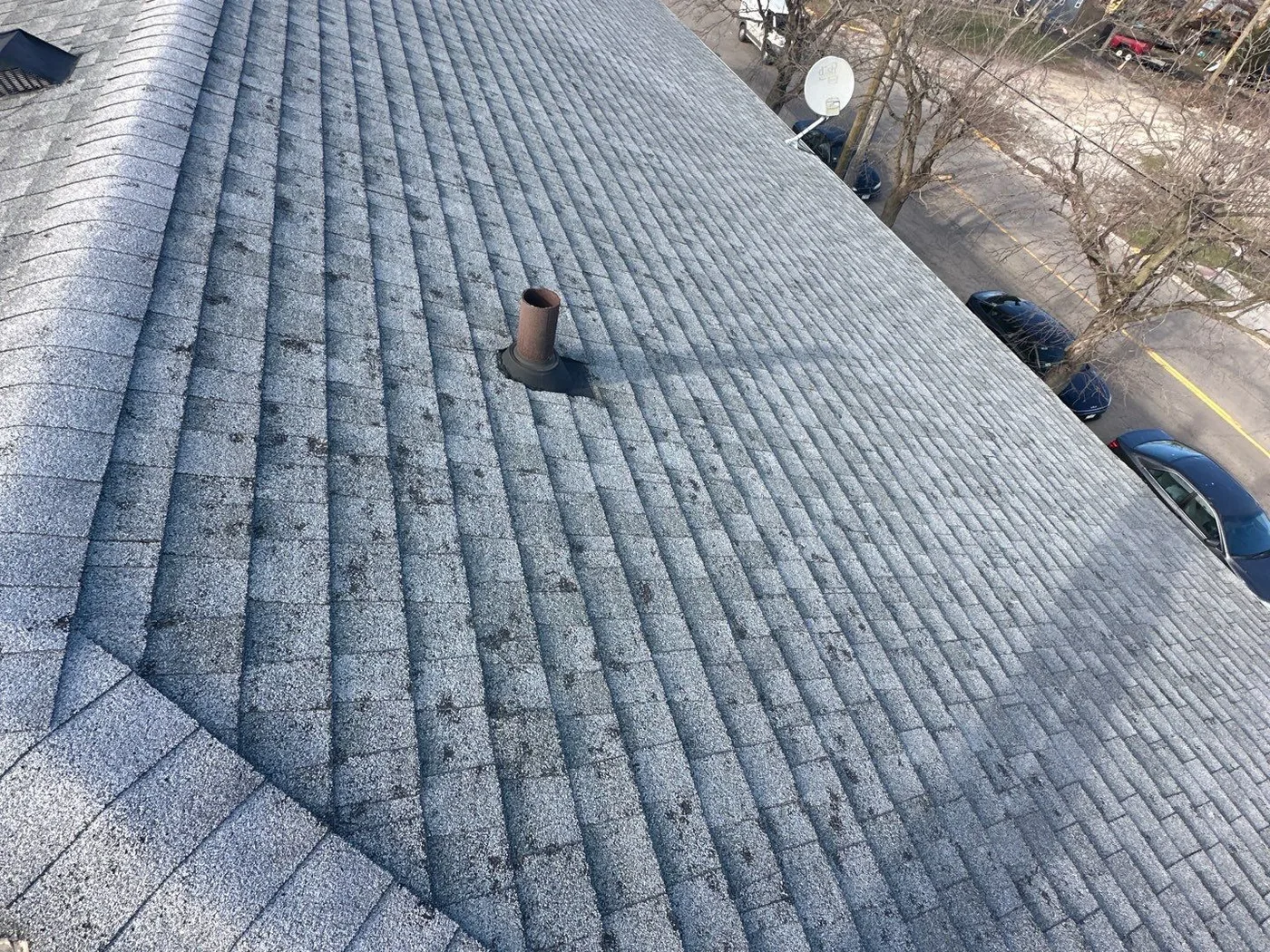 Weathered shingle roof with granule loss on a Kankakee multifamily building before the storm restoration
