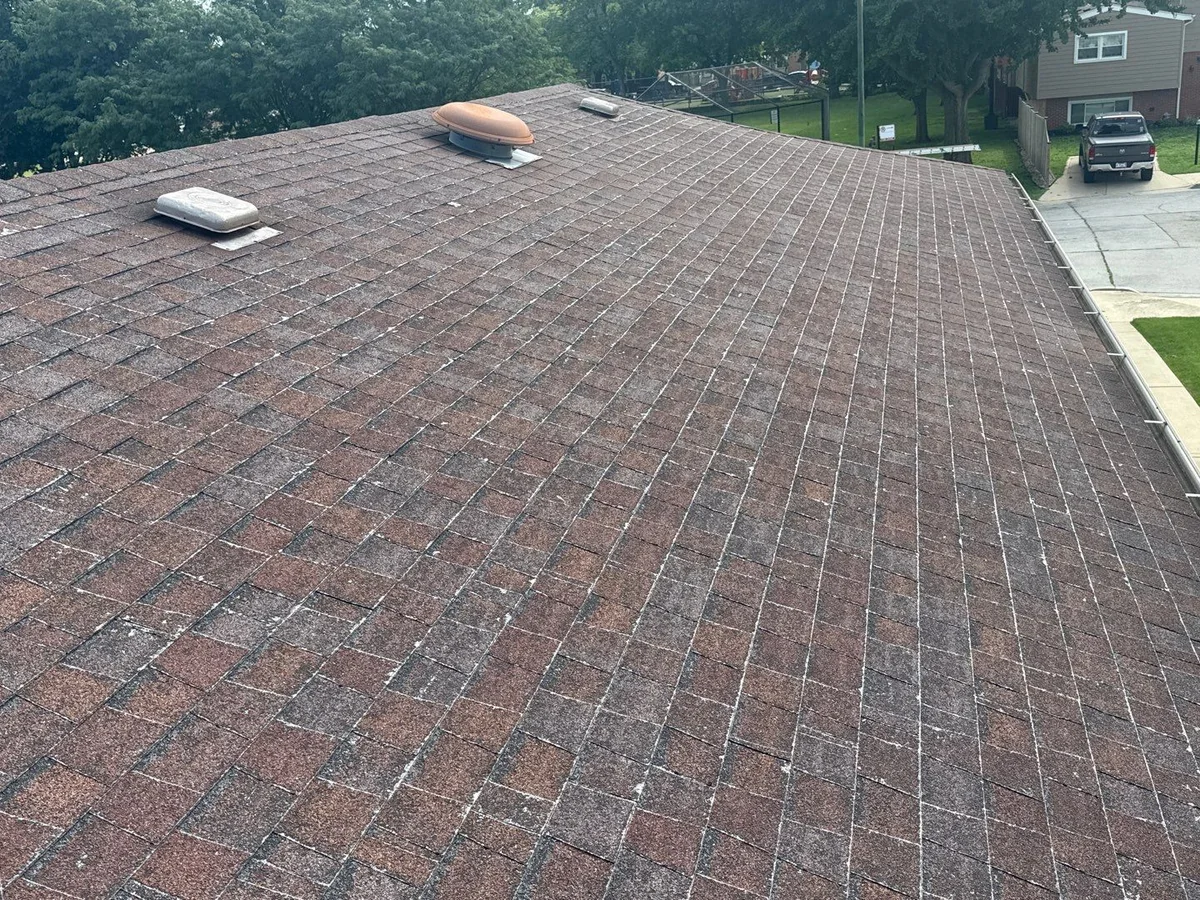 The Quinn's Chicago home with a worn, weathered shingle roof before replacement