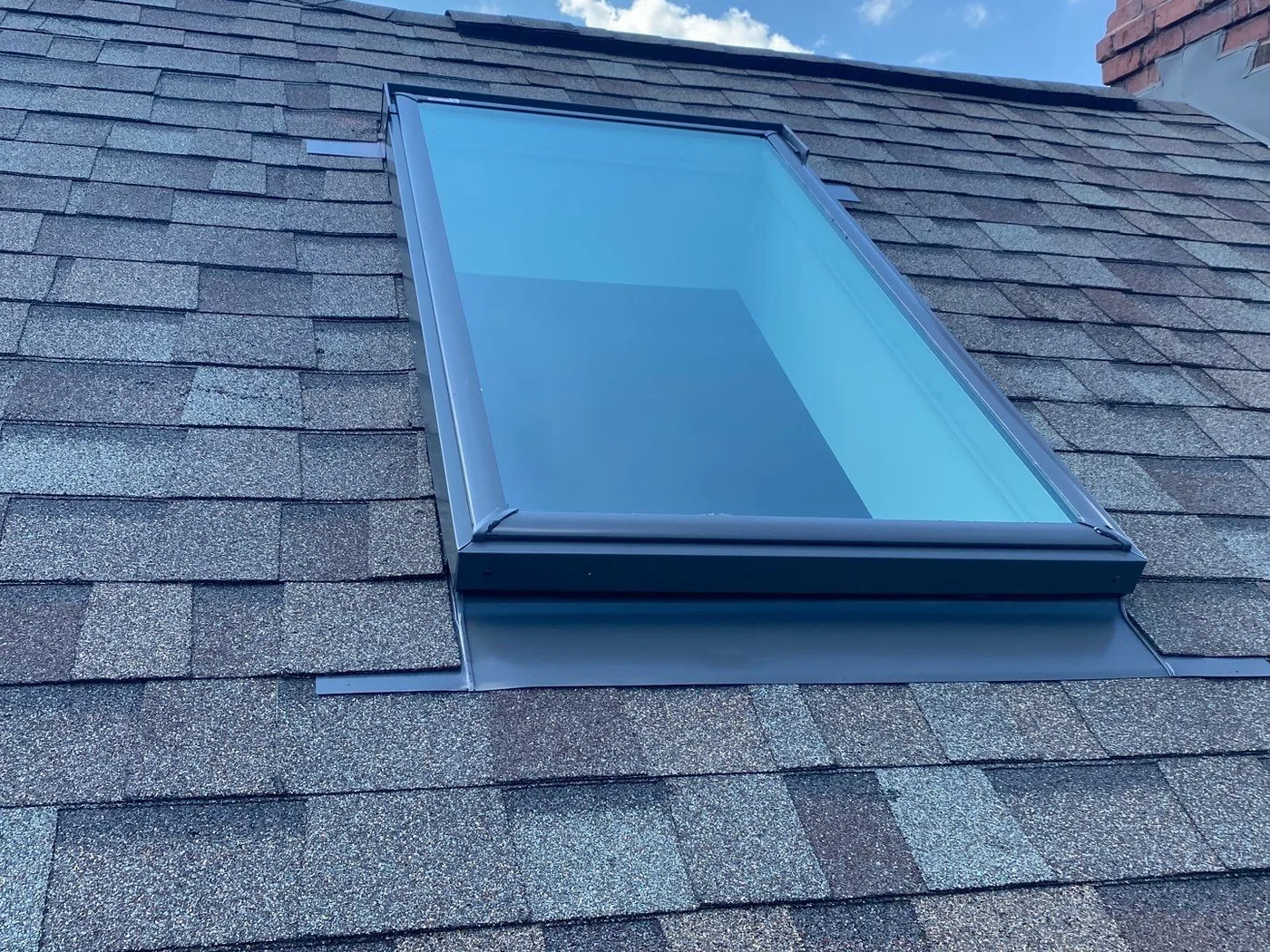 The Bahnaman's new Velux skylight with clean flashing set into a new shingle section in Mokena