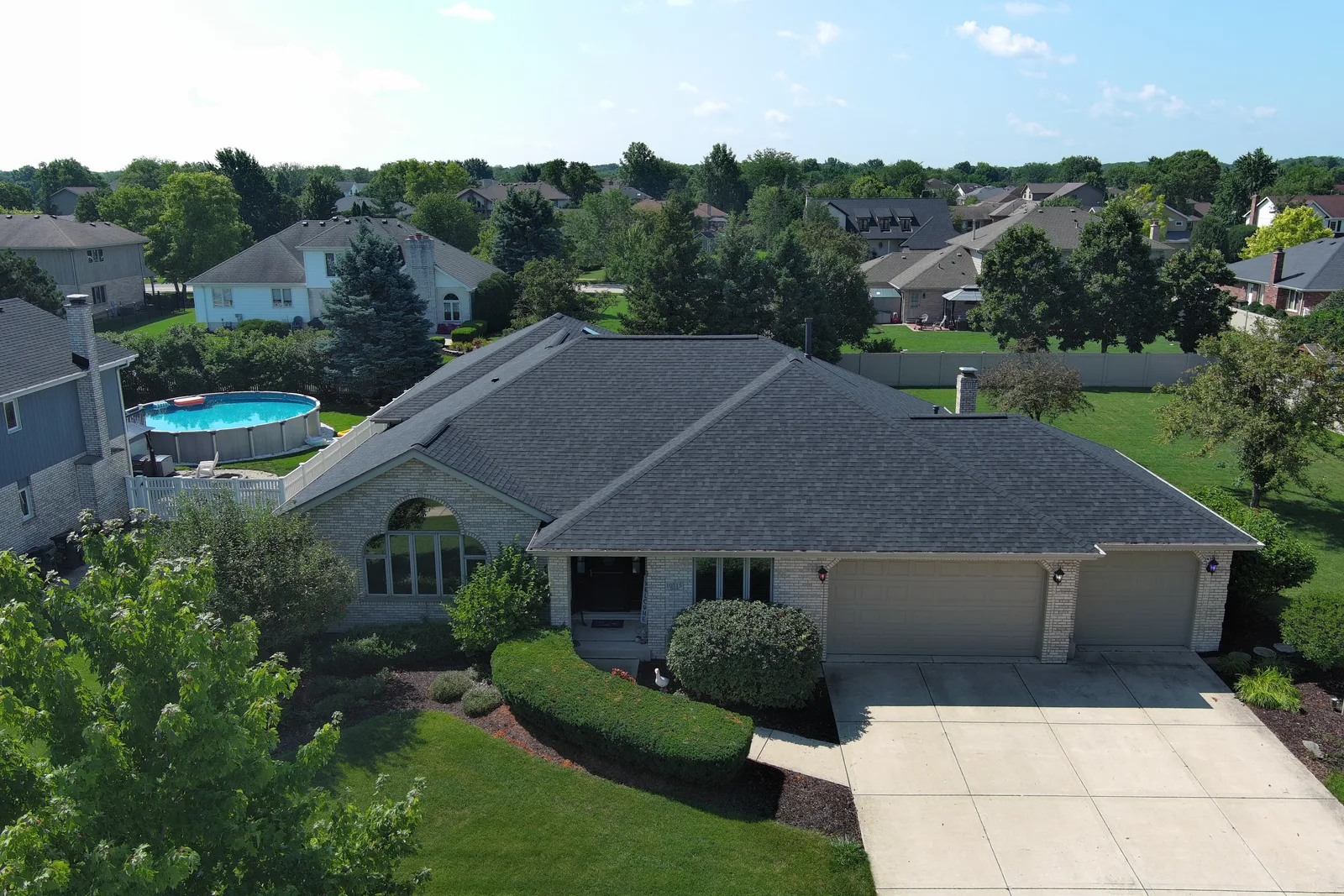 Drone view of a completed architectural shingle roof by Americanstruction