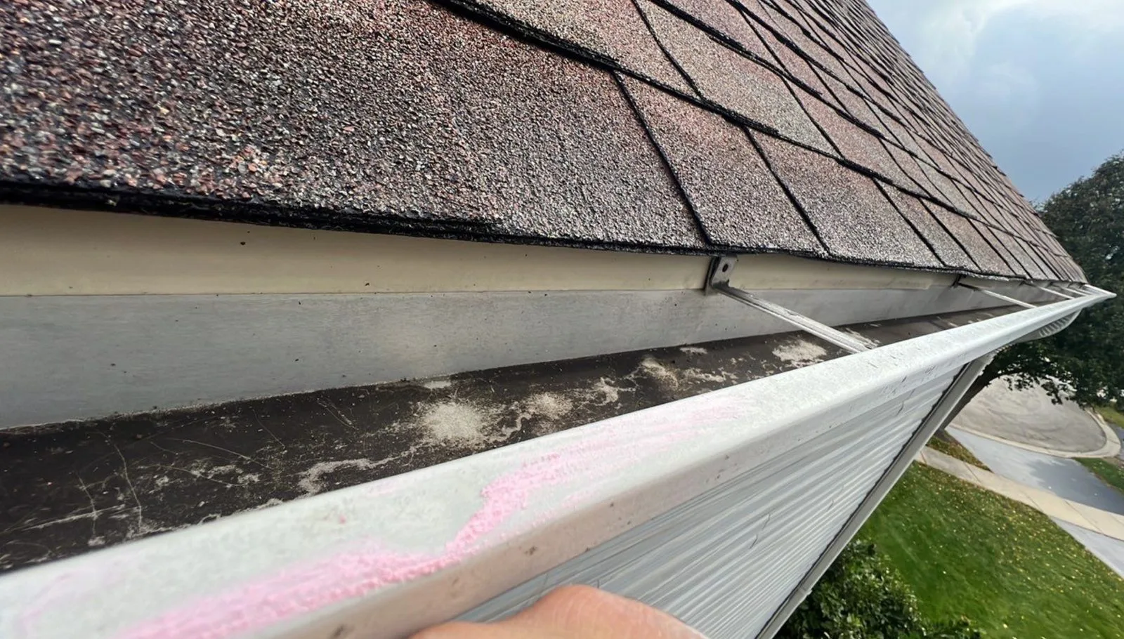Americanstruction inspector documenting storm damage on a Shorewood roof