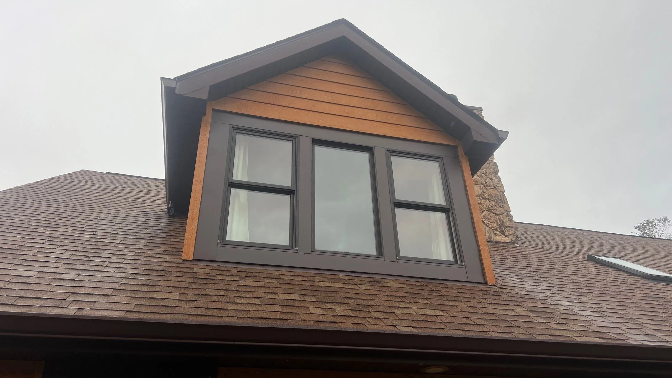 New dormer windows with dark cladding installed by Americanstruction